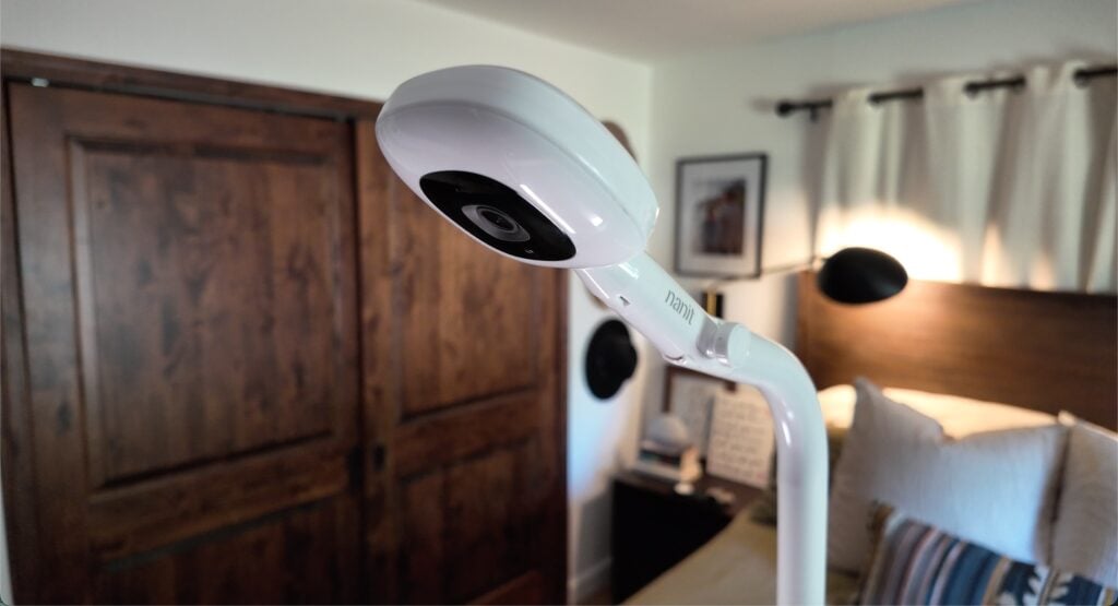 A closeup of a Nanit monitor in a bedroom