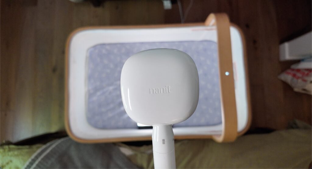 Looking down at a Nanit baby monitor overlooking a crib