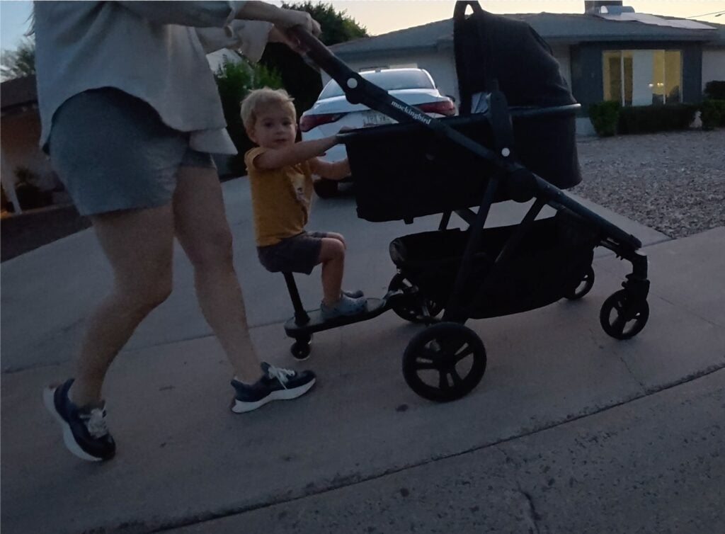 A toddler on a riding board
